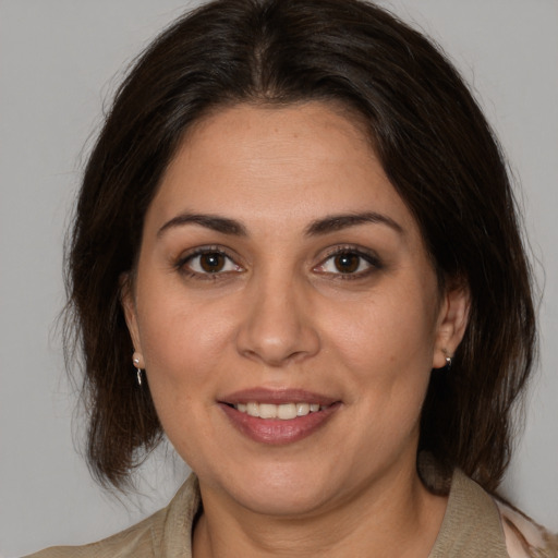 Joyful white adult female with medium  brown hair and brown eyes