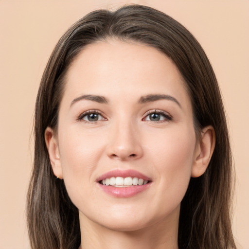 Joyful white young-adult female with long  brown hair and brown eyes