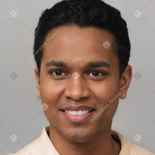 Joyful black young-adult male with short  black hair and brown eyes