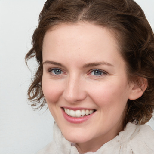 Joyful white young-adult female with medium  brown hair and blue eyes