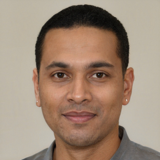 Joyful white young-adult male with short  black hair and brown eyes