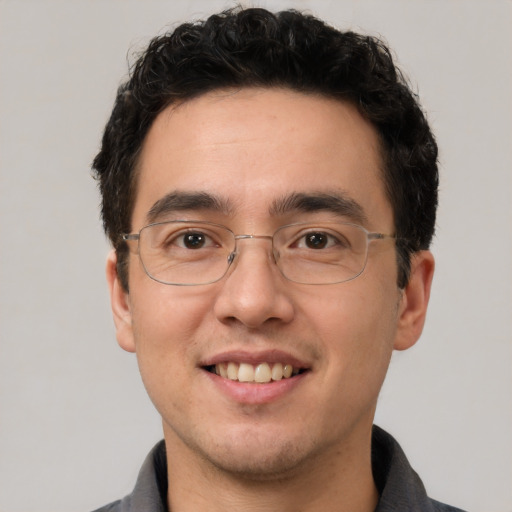 Joyful white adult male with short  black hair and brown eyes