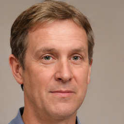 Joyful white adult male with short  brown hair and grey eyes