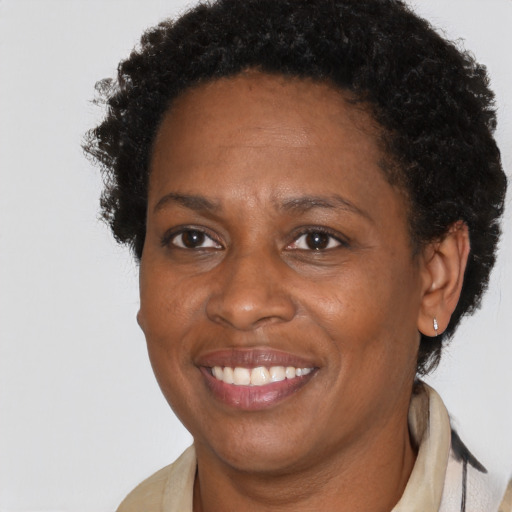 Joyful black adult female with short  brown hair and brown eyes