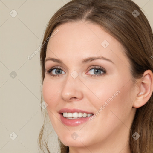 Joyful white young-adult female with long  brown hair and blue eyes