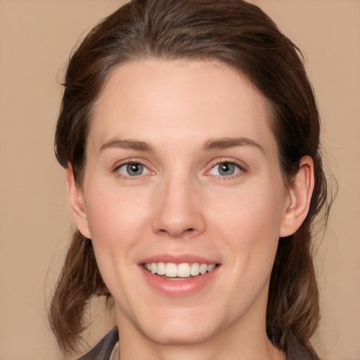 Joyful white young-adult female with medium  brown hair and brown eyes