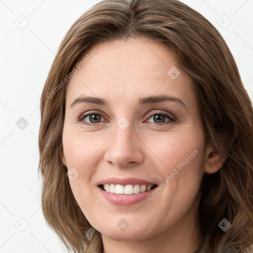 Joyful white young-adult female with long  brown hair and green eyes