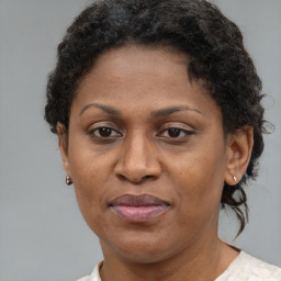 Joyful black adult female with short  brown hair and brown eyes