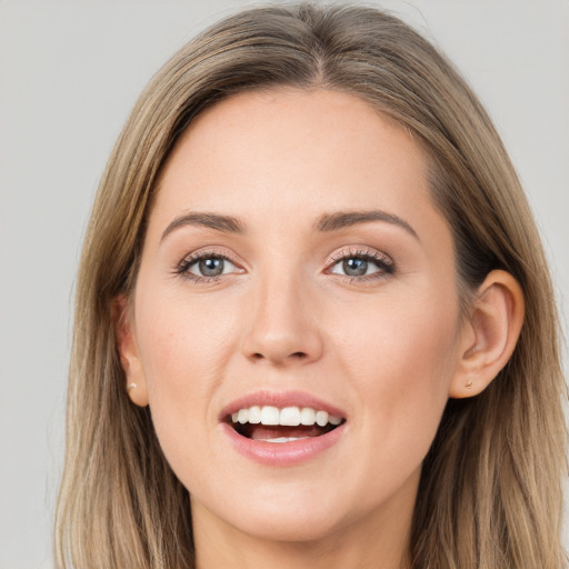 Joyful white young-adult female with long  brown hair and grey eyes