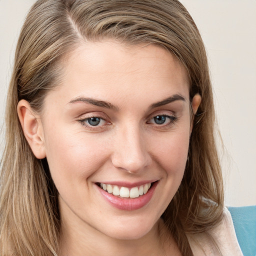 Joyful white young-adult female with long  brown hair and grey eyes