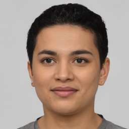 Joyful latino young-adult male with short  black hair and brown eyes