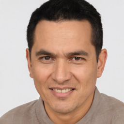 Joyful white adult male with short  black hair and brown eyes