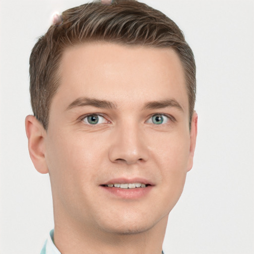 Joyful white young-adult male with short  brown hair and grey eyes