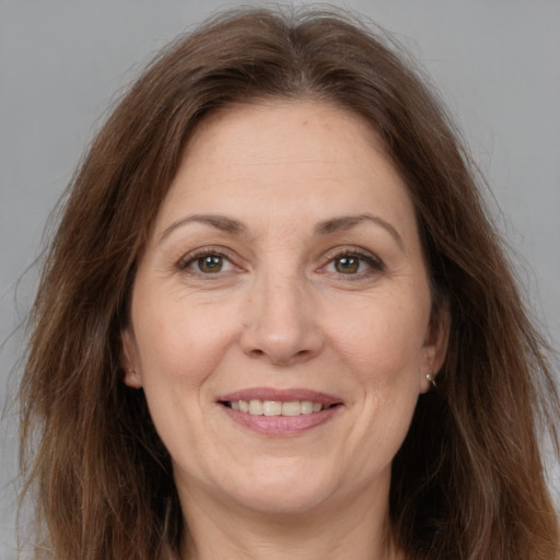 Joyful white adult female with long  brown hair and brown eyes