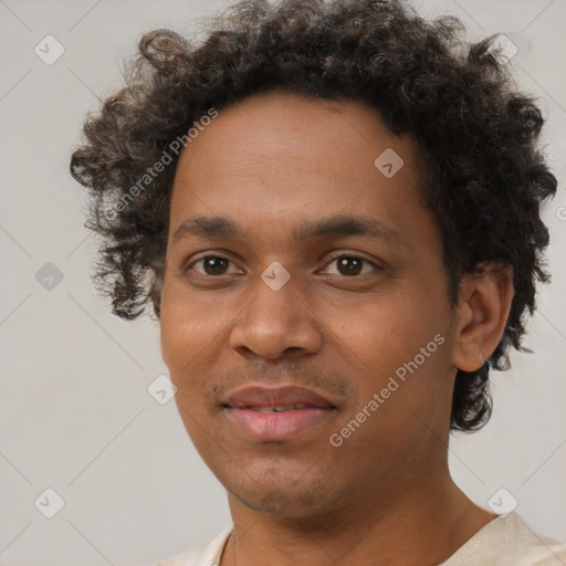 Joyful black young-adult male with short  brown hair and brown eyes