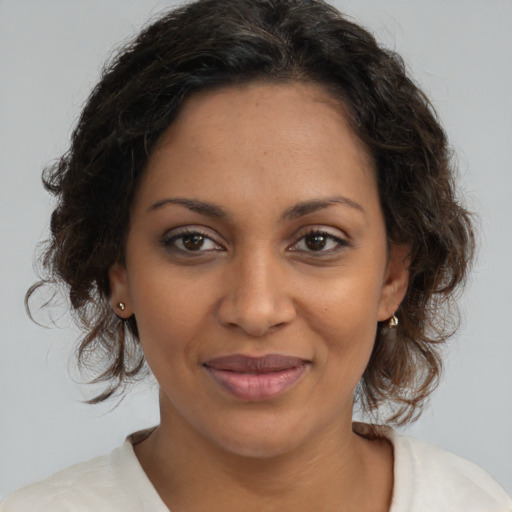 Joyful black young-adult female with medium  brown hair and brown eyes