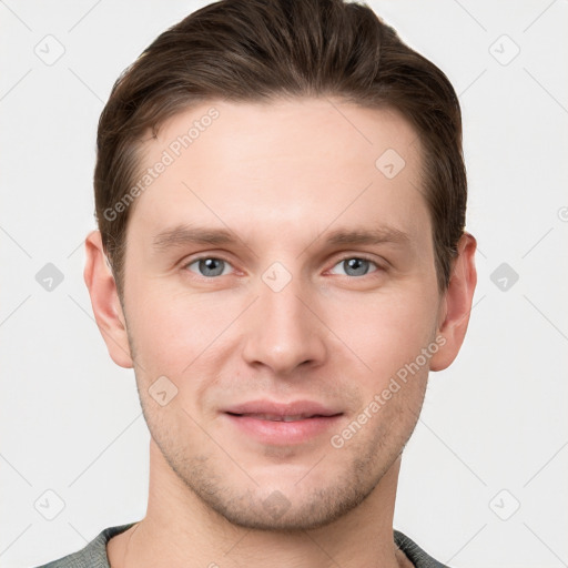 Joyful white young-adult male with short  brown hair and grey eyes