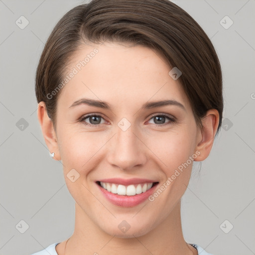 Joyful white young-adult female with short  brown hair and grey eyes