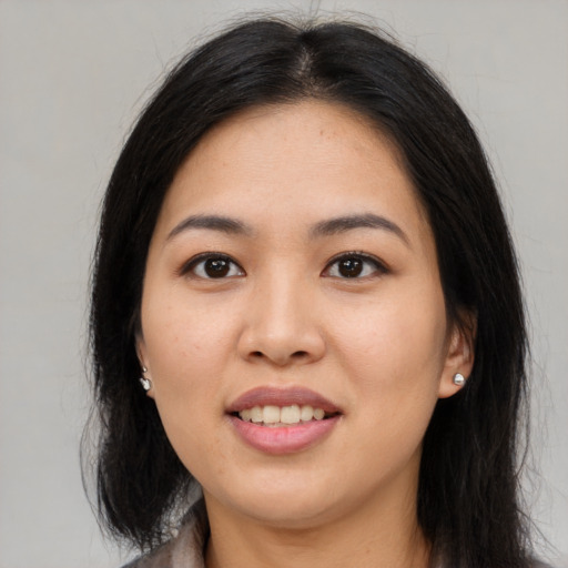 Joyful asian young-adult female with long  black hair and brown eyes