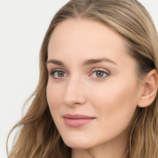 Joyful white young-adult female with long  brown hair and blue eyes