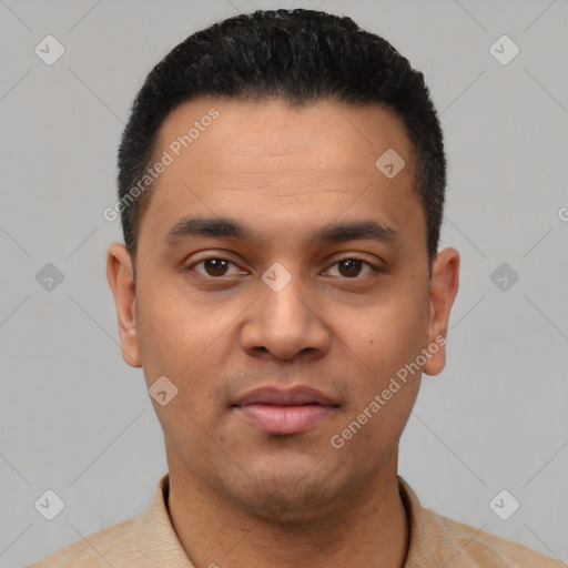 Joyful latino young-adult male with short  black hair and brown eyes