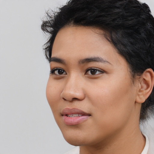 Joyful asian young-adult female with short  black hair and brown eyes