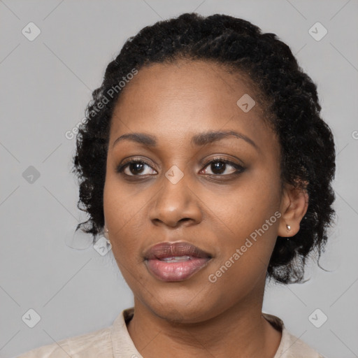 Joyful black young-adult female with medium  black hair and brown eyes