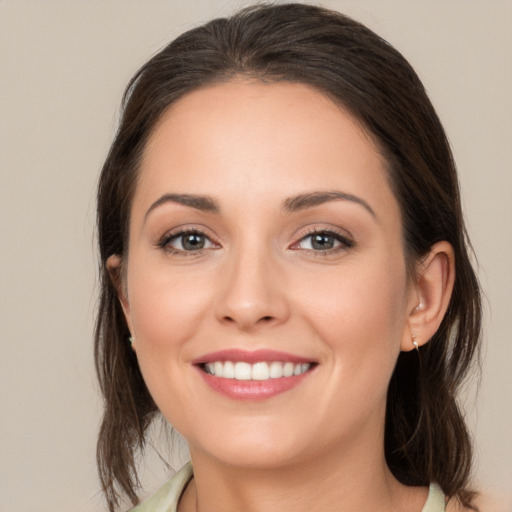 Joyful white young-adult female with medium  brown hair and brown eyes