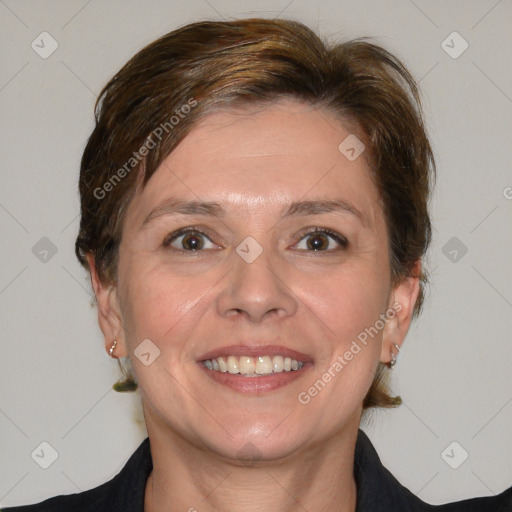 Joyful white adult female with medium  brown hair and blue eyes