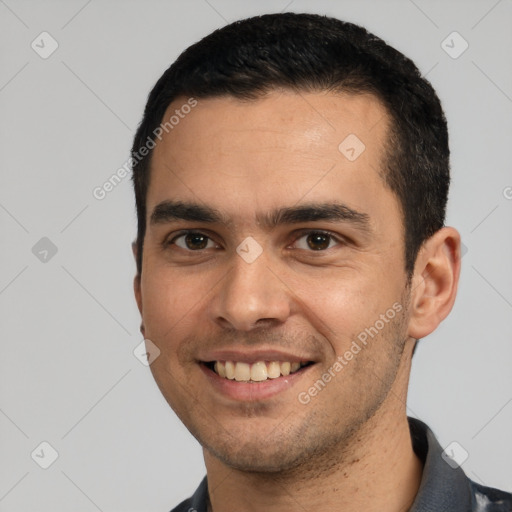 Joyful white young-adult male with short  black hair and brown eyes