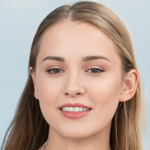 Joyful white young-adult female with long  brown hair and blue eyes