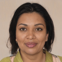 Joyful black adult female with medium  brown hair and brown eyes