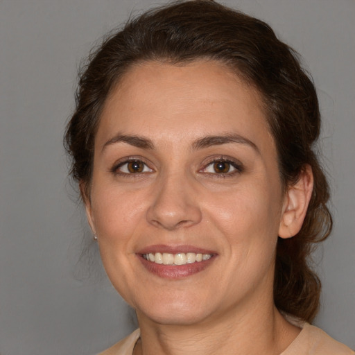 Joyful white adult female with medium  brown hair and brown eyes