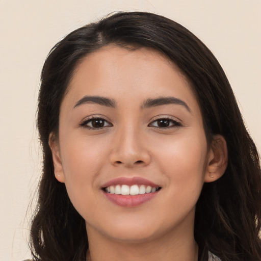 Joyful white young-adult female with long  brown hair and brown eyes