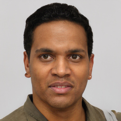 Joyful black young-adult male with short  black hair and brown eyes