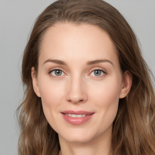 Joyful white young-adult female with long  brown hair and grey eyes