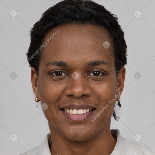 Joyful black young-adult male with short  brown hair and brown eyes