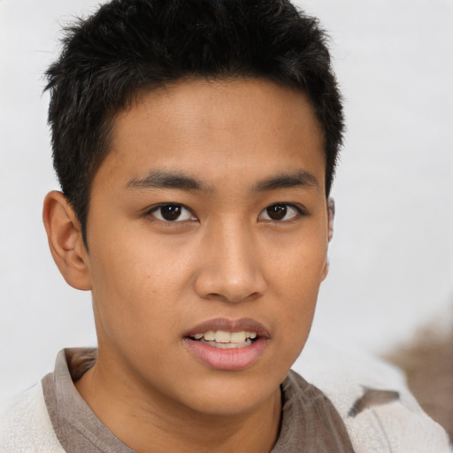 Joyful asian young-adult male with short  brown hair and brown eyes