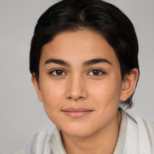 Joyful latino young-adult female with medium  brown hair and brown eyes