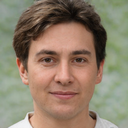 Joyful white adult male with short  brown hair and brown eyes