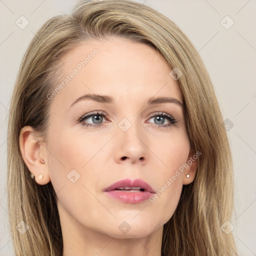 Joyful white young-adult female with long  brown hair and blue eyes