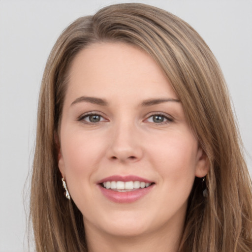 Joyful white young-adult female with long  brown hair and grey eyes