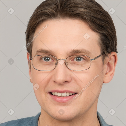 Joyful white adult male with short  brown hair and grey eyes