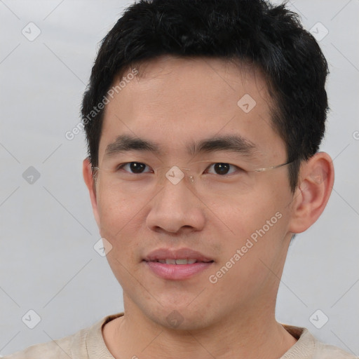 Joyful asian young-adult male with short  brown hair and brown eyes