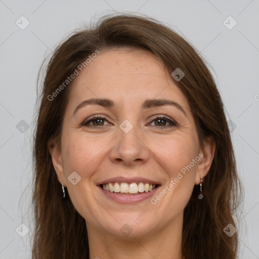 Joyful white adult female with long  brown hair and brown eyes