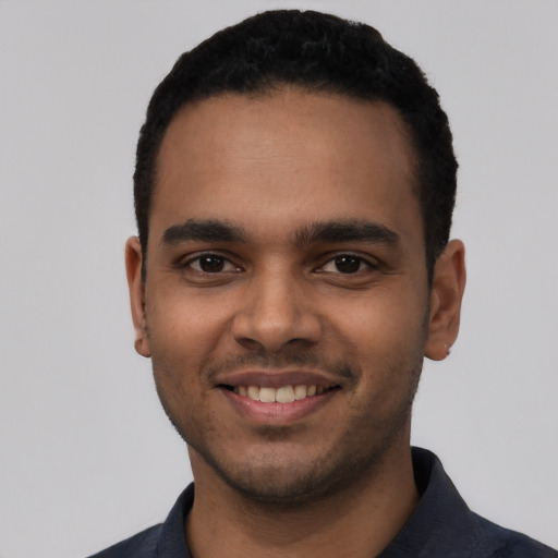 Joyful latino young-adult male with short  black hair and brown eyes
