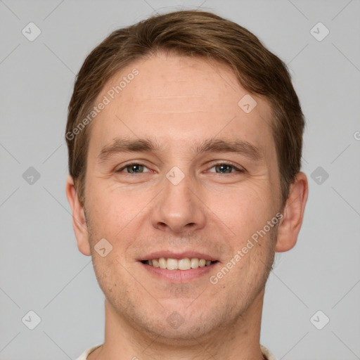 Joyful white young-adult male with short  brown hair and grey eyes