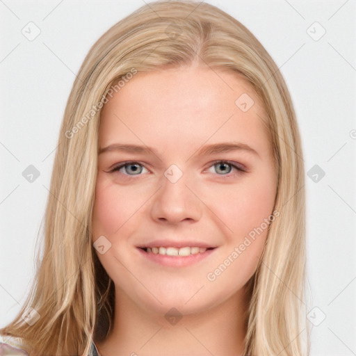 Joyful white young-adult female with long  brown hair and blue eyes