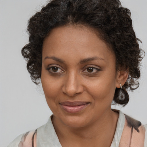 Joyful black young-adult female with medium  brown hair and brown eyes