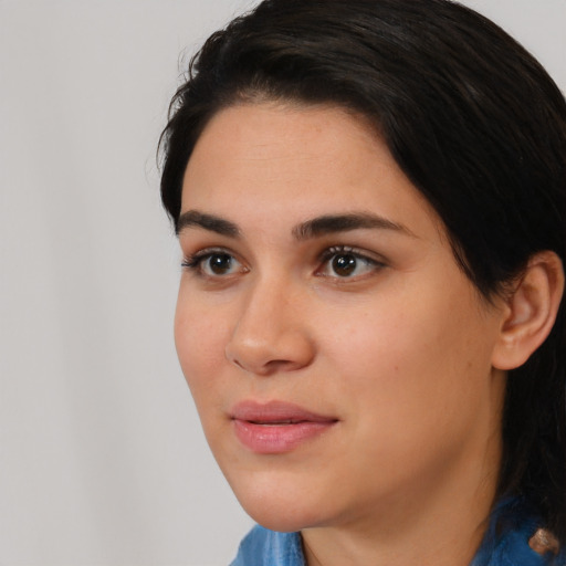 Joyful white young-adult female with long  black hair and brown eyes